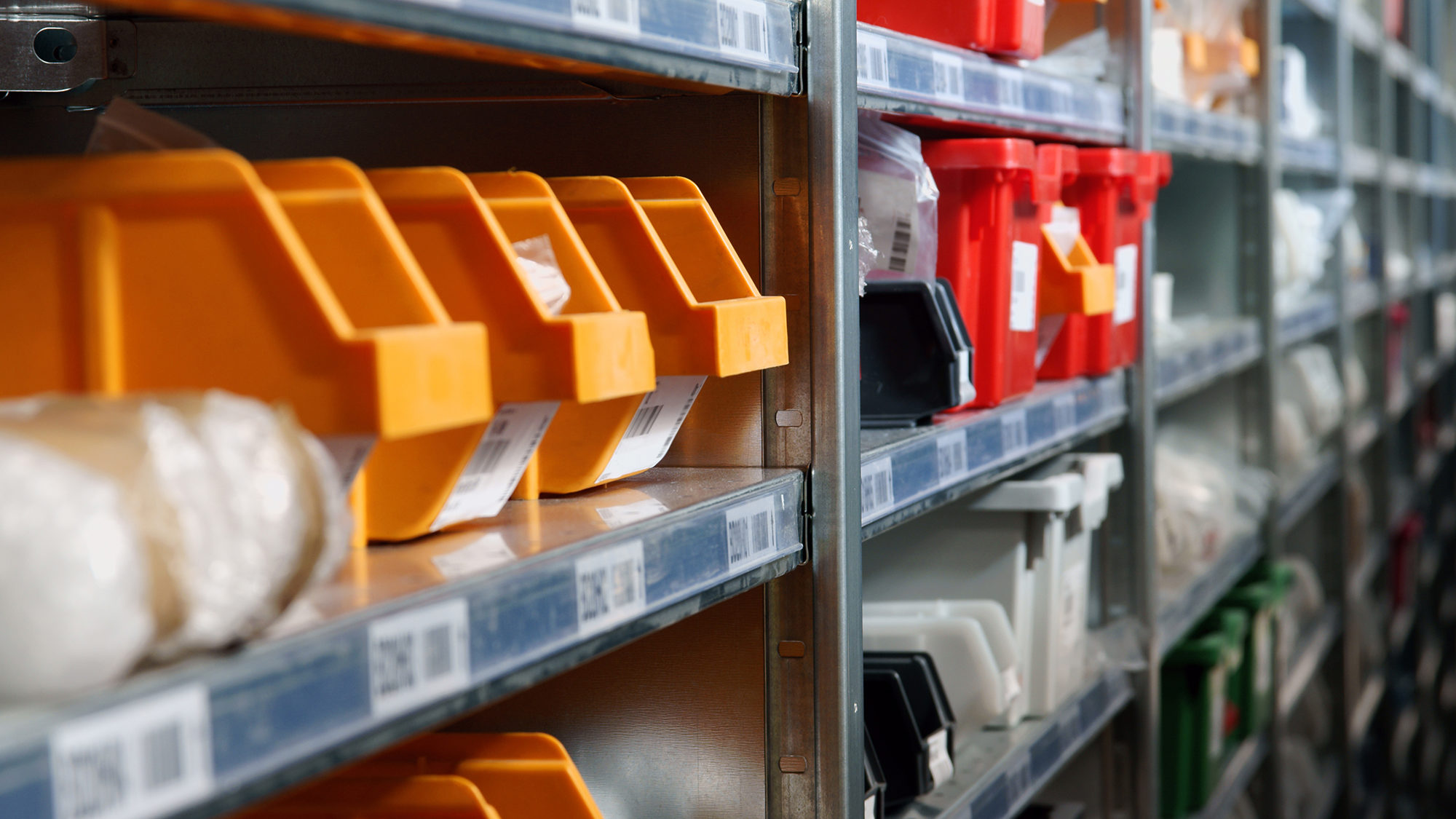 Storage bins and racks in a warehouse shot with selective focus